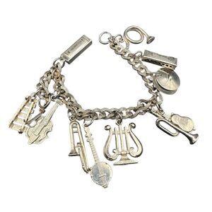 Orchestra charm bracelet vintage gold tone with 11 charms